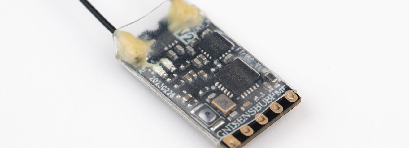 Flysky FTr16S AFHDS3 micro receiver showing dual antennas and serial output connection pads | SoarSky