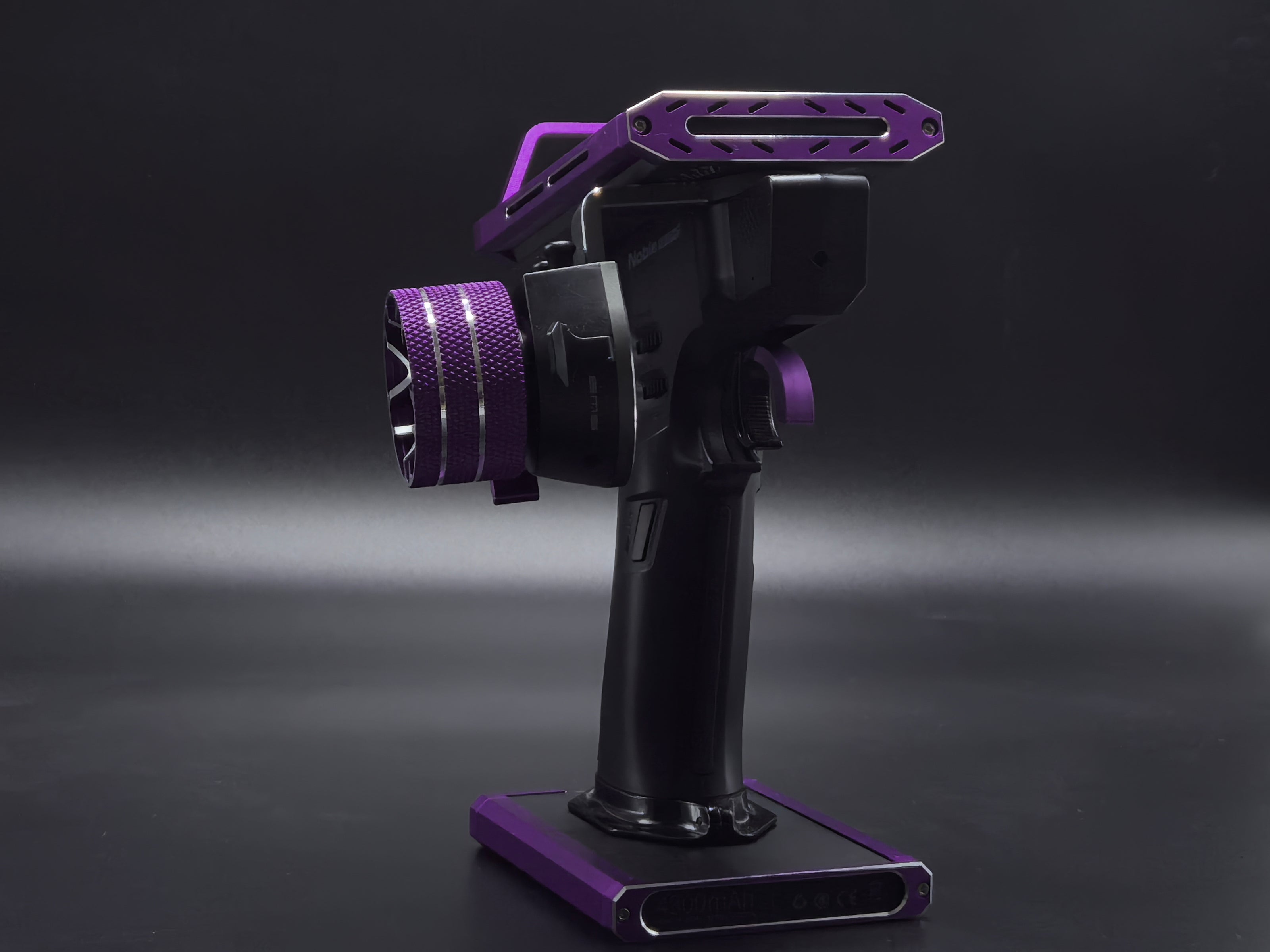 Black and purple camera stabilizer on a dark background