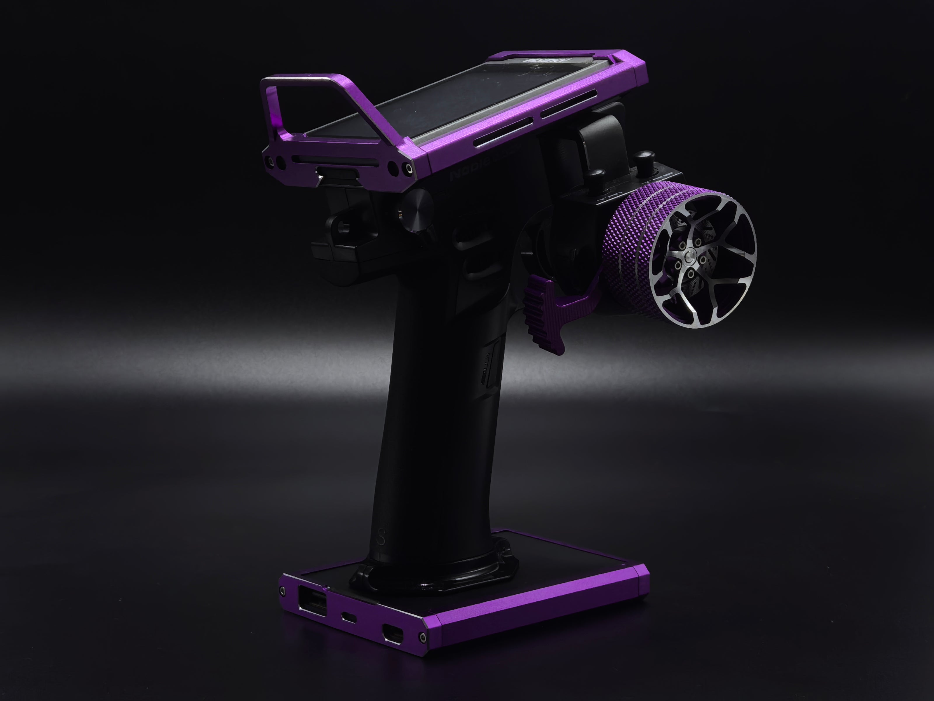 Black and purple fishing reel stand on a dark background
