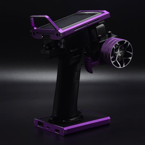 Black and purple fishing reel stand on a dark background